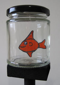 Small card fish swimming in a jar